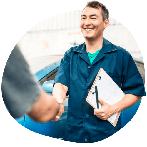 a business owner smiling and shaking hands with a customer