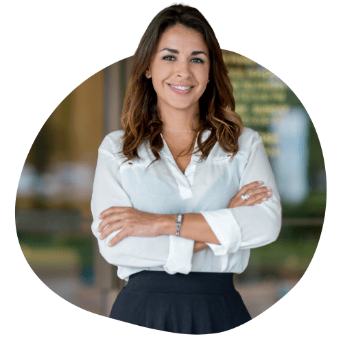 a female business owner smiling with her arms crossed