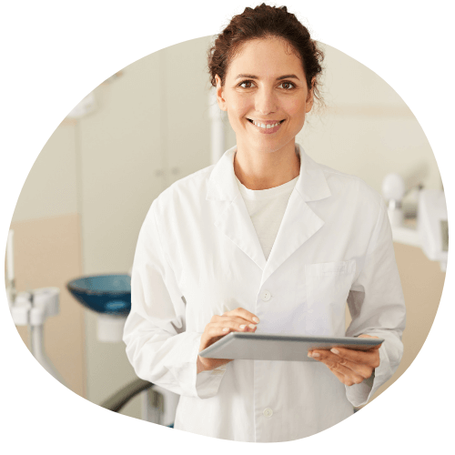 a female dentist smiling in a white lab coat