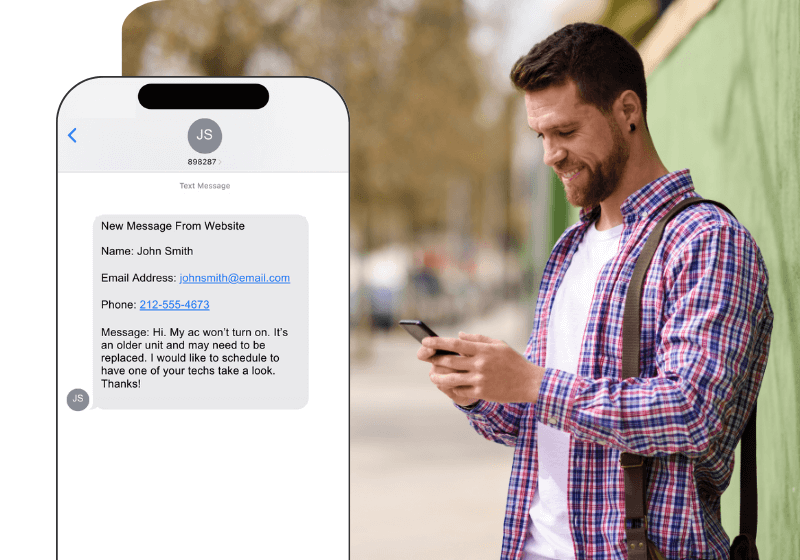 The owner of an HVAC company smiling at a lead texted to his phone from his wensite.